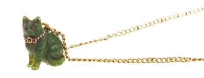 Lot Carved green hardstone cat pendant with garnet and seed pearl collar, on a yellow metal chain
