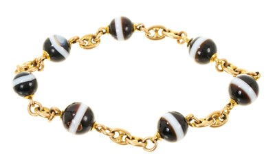 Lot 447 - Victorian yellow metal mariner link bracelet with seven banded agate beads