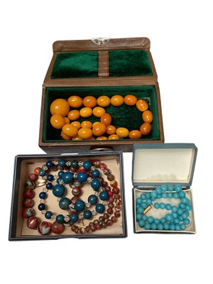 Lot 98 - Vintage amber bead necklace, together with other vintage beads and a small leather jewellery box