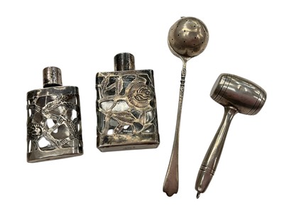 Lot 1002 - Child's sterling silver rattle in the form of a gavel, sterling strainer and two silver cased scent bottles (4)