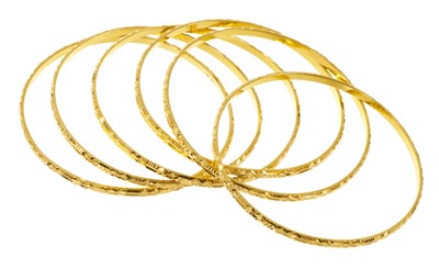 Lot Six yellow metal bangles, from Guyana, stamped 22K