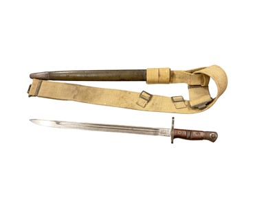 Lot 954 - First World War American 1917 pattern Remington bayonet in scabbard, together with a Second World War canvas webbing sword belt dated 1942 (2).