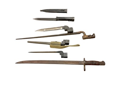 Lot 958 - First World War American 1917 pattern Remington bayonet (no scabbard), Second World War British Spike bayonet in scabbard with canvas webbing frog, another spike bayonet, a