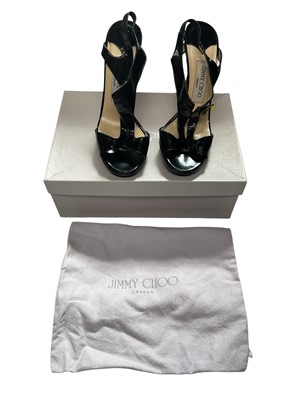 Lot 2128 - Jimmy Choo Glossy kid black Grove shoes size 37 with box, dust bags and spare heel tips. Plus Jimmy Choo black purse and Burberry card holder.
