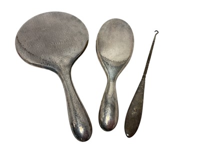 Lot 23 - Dutch silver plated dressing table mirror and matching brush (both marked Gero 90) with hammered finish, together with a silver handled button hook (3)