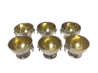 Lot 252 - Set of six contemporary silver bowls with lion mask ring handles, raised on circular feet with gilded interiors, (Birmingham 1962), maker Turner & Simpson Ltd, each 5.5cm.