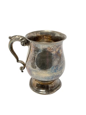 Lot 244 - George V silver tankard of baluster form, with scroll handle, raised on a circular foot, (Birmingham 1930), maker Roberts & Doore Ltd, 13.5cm in overall height, 9ozs.