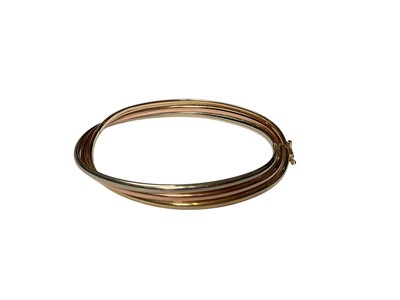 Lot 24 - 9ct three colour gold triple row twisted bangle