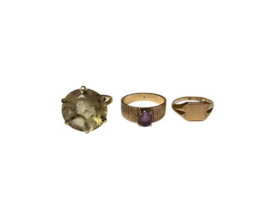 Lot 29 - 9ct gold large citrine single stone cocktail ring, 9ct gold amethyst ring in four claw setting on bark effect shank and 9ct gold signet ring (3)