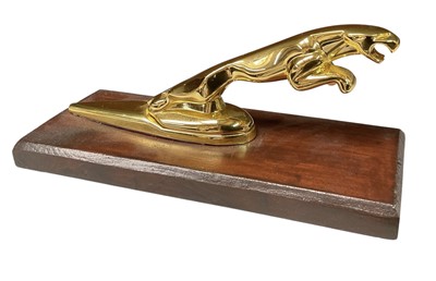 Lot Jaguar Cars, gold plated leaping cat car mascot, mounted on wooden plinth, approximately 17cm in overall length.