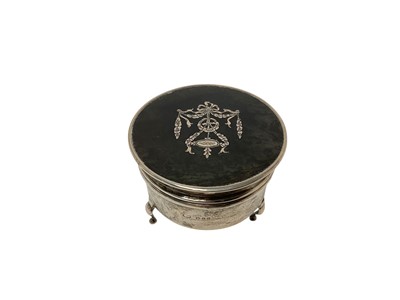 Lot 250 - George V silver and tortoiseshell jewellery / ring box of circular form, raised on three hoof feet, (London 1919), makers mark rubbed, 5.4cm in overall height.