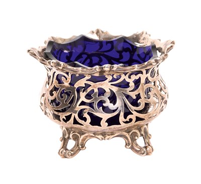 Lot 258 - Victorian silver sugar bowl with pierced decoration and with blue glass liner, raised on four scroll feet, (London 1846), maker Charles Reily and George Storer, 3ozs, 6cm in overall height.