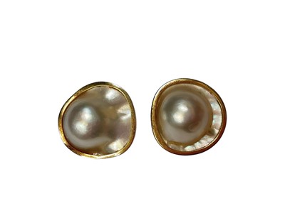 Lot 156 - Pair mabé pearl earrings in gold ear clip settings (one marked 14K, the other 585)