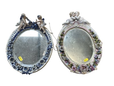 Lot 5071 - Two Continental porcelain dressing table mirrors with figural decoration, (2).