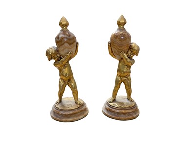 Lot 5070 - Pair of Continental figures of putti holding obelisks, on marble bases.