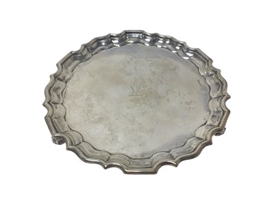 Lot 284 - George V silver salver / card tray with engraved armorial and piecrust edge, raised on three scroll feet, (London 1913), maker Thomas Bradbury, 16cm diameter, 6oz.