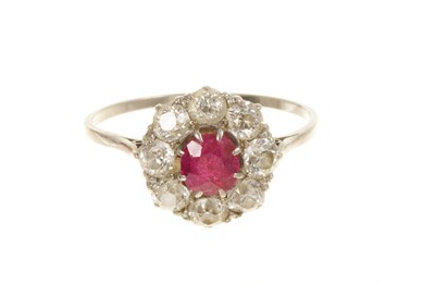 Lot Ruby and diamond cluster ring with central ruby surrounded by eight old cut diamonds in claw setting in platinum shank, circa 1920