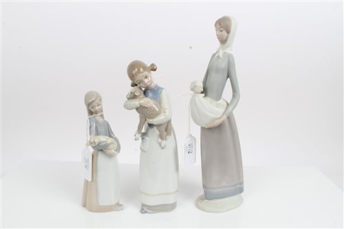 Lot 2136 - Two Lladro porcelain figures - girl holding...