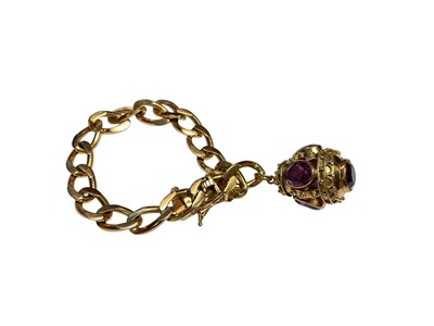 Lot 119 - Continental yellow metal flat curb link bracelet with a yellow metal egg shaped pendant set with synthetic alexanderite/purple stones