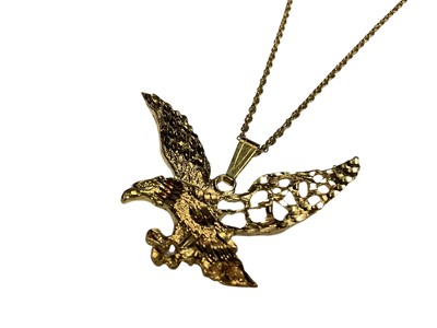 Lot 124 - Yellow metal flying eagle pendant on 9ct gold chain