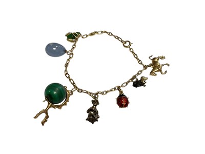 Lot 28 - Yellow metal charm bracelet with seven various novelty charms