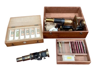 Lot 2505 - Antique brass student's microscope in case by 'Jas Parkes & Son Birmingham', together with another student's microscope and two cases of antique slides, including insects and flowers