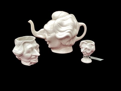 Lot 1227 - Luck & Flaw Spitting Image Margaret Thatcher teapot and matching jug, together with a similar piece (3)