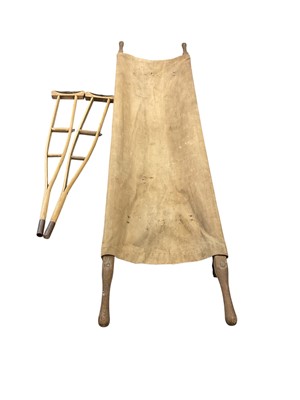 Lot 814 - Second World War period wood and canvas folding stretcher, together with a pair of wooden crutches, (3).