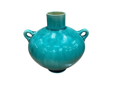 Lot 1292 - Dr Christopher Dresser for Linthorpe Pottery twin handled green glazed vase, 11cm high