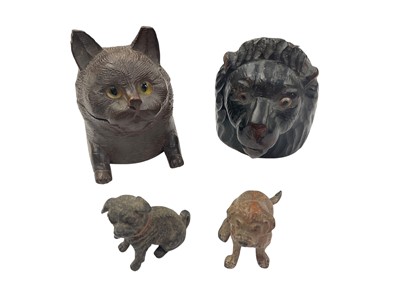 Lot 142 - Two carved wood novelty inkwells in the form of a car and lion, together with two cold painted dogs (4)