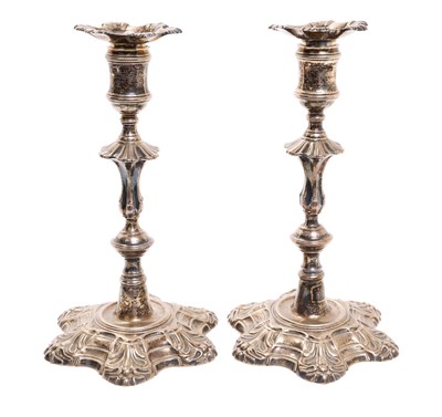 Lot 295 - Pair of George II cast silver candlesticks, with detachable scones, baluster stems, on scalloped bases, (London 1751), possibly by William Denny, 22cm high, 39oz.