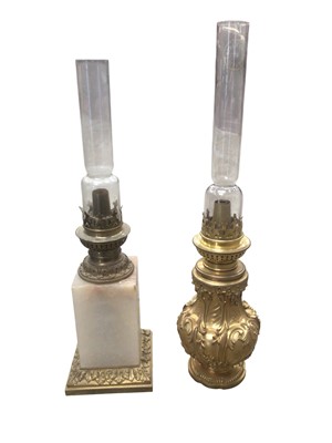 Lot 2601 - Edwardian ormolu rococo-style oil table lamp and three others, two with ruby glass shades (4)