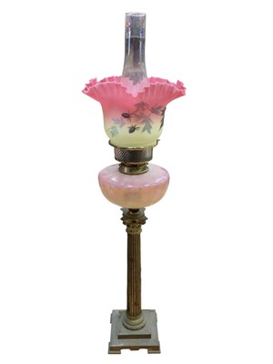 Lot 2615 - Victorian gilt brass Corinthian column oil lamp with pink tinted glass reservoir and pink and yellow satin glass shade with handkerchief border 83cm high