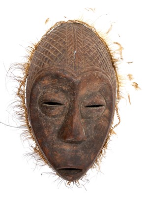 Lot 749 - Tribal mask, Congo, carved feature and diaper ornament, 34cm high