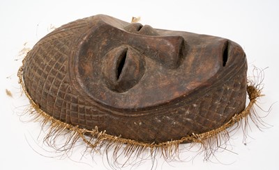Lot 749 - Tribal mask, Congo, carved feature and diaper ornament, 34cm high