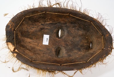 Lot 749 - Tribal mask, Congo, carved feature and diaper ornament, 34cm high