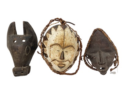 Lot 752 - Dan tribal mask, with woven hair, 25cm high, and two further tribal masks - Guatemalan animal mask and Fang painted mask