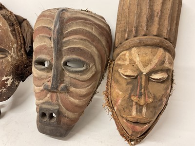 Lot 753 - Four African tribal masks, including a Kuba mask with shell, cloth and bead ornament, Yoruba mask, Fang mask and a polychrome painted Basonge mask. (4)