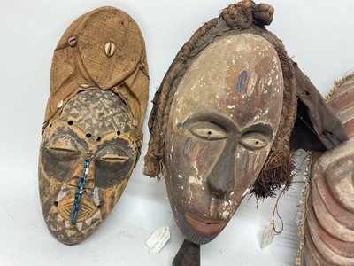 Lot 753 - Four African tribal masks, including a Kuba mask with shell, cloth and bead ornament, Yoruba mask, Fang mask and a polychrome painted Basonge mask. (4)