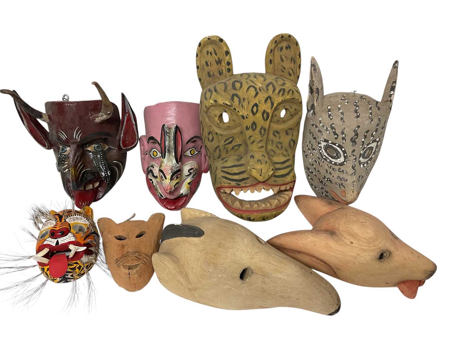 Lot 756 - Central American carved animal and devil masks, the largest, a leopard mask, 40cm high. (8)