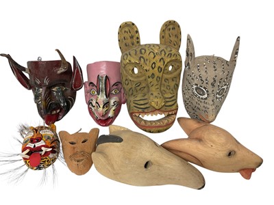 Lot 756 - Central American carved animal and devil masks, the largest, a leopard mask, 40cm high. (8)