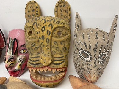 Lot 756 - Central American carved animal and devil masks, the largest, a leopard mask, 40cm high. (8)