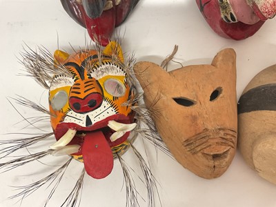 Lot 756 - Central American carved animal and devil masks, the largest, a leopard mask, 40cm high. (8)