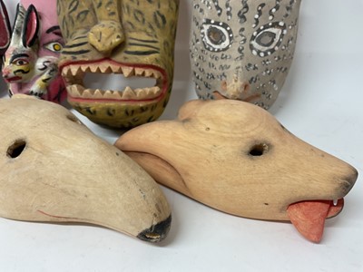 Lot 756 - Central American carved animal and devil masks, the largest, a leopard mask, 40cm high. (8)
