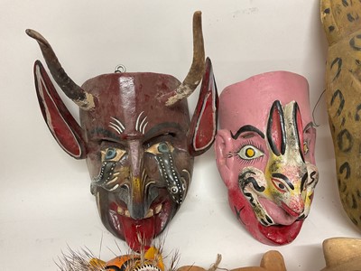 Lot 756 - Central American carved animal and devil masks, the largest, a leopard mask, 40cm high. (8)