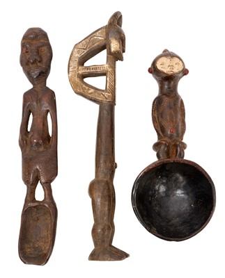 Lot 757 - Tribal ceremonial spoon, Gabon, with figural handle, 23cm long, together with a Baule gong beater and Nigerian figural spoon. (3)