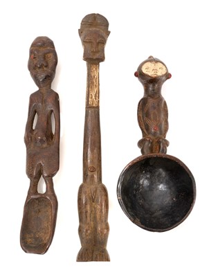 Lot 757 - Tribal ceremonial spoon, Gabon, with figural handle, 23cm long, together with a Baule gong beater and Nigerian figural spoon. (3)
