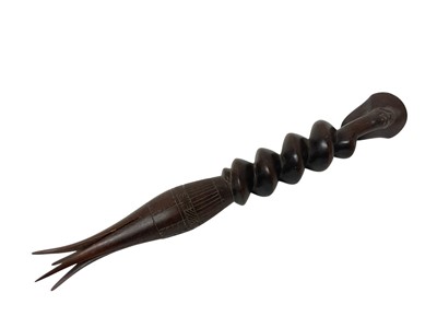 Lot 759 - Dyak headhunter sword, with antler handle and embellished with polychrome ornament and hung with teeth, 68cm long, together with cannibal fork. (2)