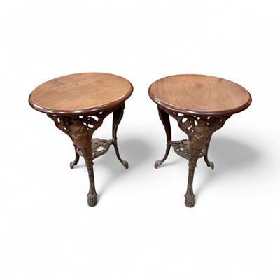 Lot 1273 - Pair of 19th century cast iron pub tables, with circular hardwood top on figural frame supports and paw feet