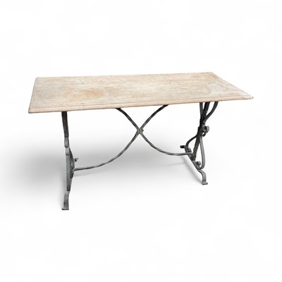 Lot 1284 - Wrought iron and oak side table, with moulded rectangular top on ornate standard ends